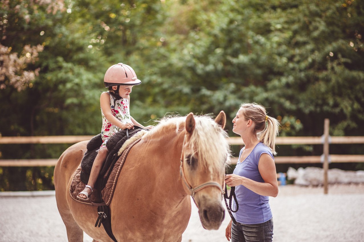 Little Girl Taking Horse-Riding Lessons